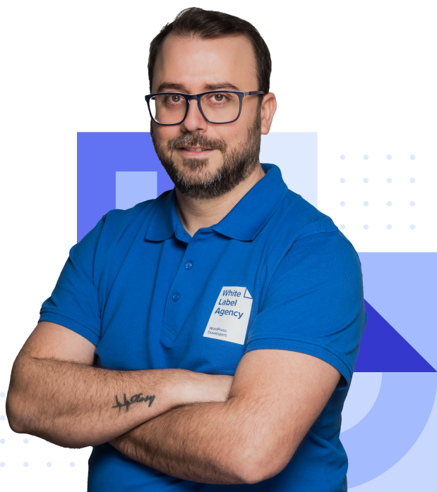 Elie Ziadeh, Account Manager at White Label Agency, wearing a branded blue polo shirt, smiling with glasses and arms crossed.